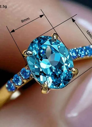 Anello di Lusso Huitan per Donna, Versatile Accessorio Dorato per Feste, Stile Semplice con Incastonatura di Zirconi Blu Brillanti, Gioiello Elegante per Matrimoni
